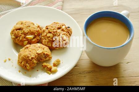 cereal cookie and coffee cup on wooden table Stock Photo