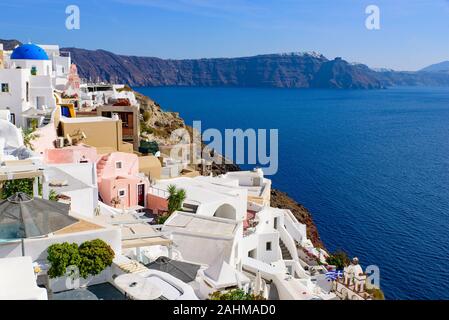 Traditional white buildings facing Mediterranean Sea in Oia, Santorini island, Greece Stock Photo