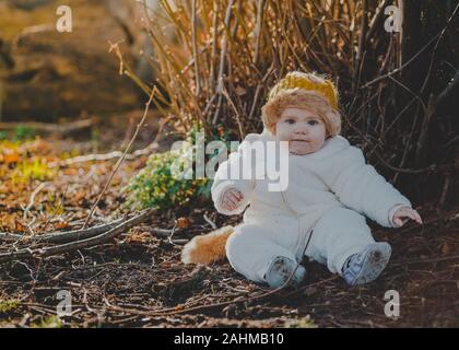 Little boy dressed as Max from Where The Wild Things Are in the woods