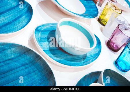 multi-colored dishes utensils on a white background Stock Photo