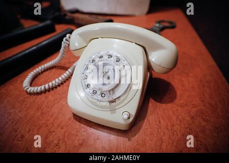 Details with a white old fashioned dial rotary phone from the