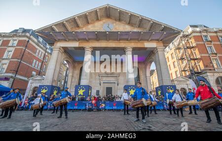 Covent Garden Piazza, London, UK. 30th December 2019. Marching bands and world music greets spectators for the LNYDP 2020 preview in central London. Image: Performance by members of the London School of Dhol. Credit: Malcolm Park/Alamy.