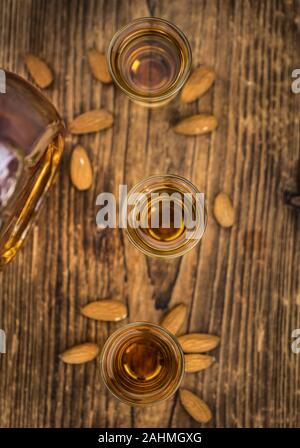Amaretto on an old wooden table (selective focus) Stock Photo