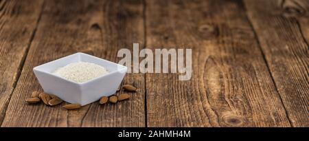 Portion of fresh Powdered Almonds on an old wooden table Stock Photo