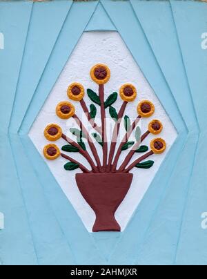 Colourful plaster floral design with a light blue background Photographed as a wall decoration in Nazare, Portugal Stock Photo