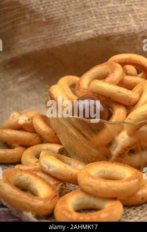 Small bagels, brown sugar and ceramic dishes on a wooden background close-up Stock Photo