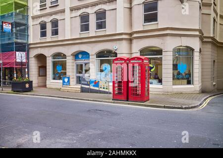 Two traditional red phone boxes in front of Barclays Eagle Lab start up hub in Victoria Street, Douglas, Isle of Man Stock Photo