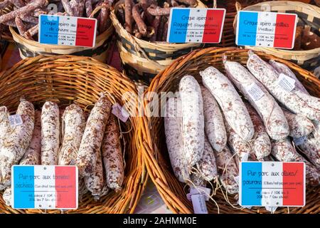 French sausages and cured salamis for sale on market day, Place Allende, Morlaix, Finistère, Brittany, France Stock Photo