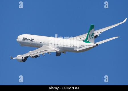 Barcelona, Spain - June 02, 2019: Mahan Airlines Airbus A340-600 banking left after taking off from El Prat Airport in Barcelona, Spain. Stock Photo