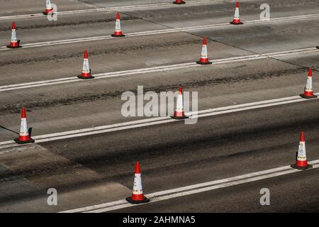 Traffic cones on multi lane highway road Stock Photo