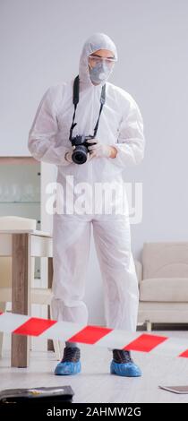 The forensic expert at crime scene doing investigation Stock Photo