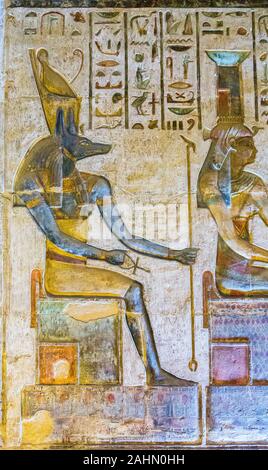 UNESCO World Heritage, Thebes in Egypt, ptolemaic temple of Deir el Medineh. The goddess Nephthys and the god Anubis seat on thrones. Stock Photo