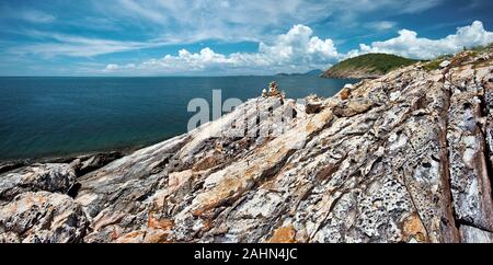 Stone texture of Wild Western coastline of Ko Samet Island and transparent water of the gulf of Thailand situated in Thai province Rayong Stock Photo