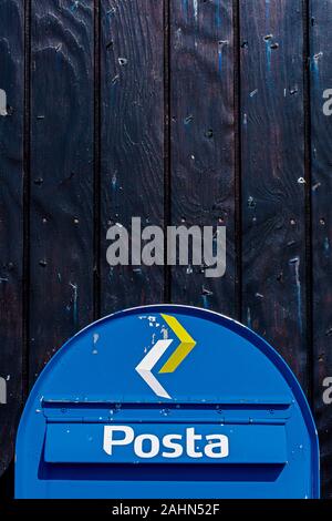 Kirkjubour, Faroe – July 11, 2018   The Poste box of Faroese postal service fixed at the black pained wooden wall. Stock Photo