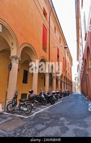 BOLOGNA, ITALY - JULY 10, 2019: Ancient residential architecture with colonnade in city historic centre, Galliera narrow street. Bologna is the capita Stock Photo