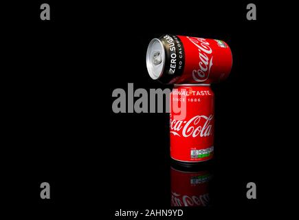 Amsterdam,28-12-2019: tow Coca-Cola Zero can 330 ml ,one original taste and one no sugar, produced by The Coca-Cola Company isolated on black background, It's popular soft drink soda sold in vending machines and general store. Stock Photo