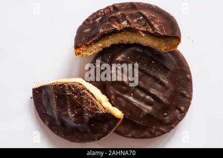 Two McVities Lemon & Lime Jaffa Cakes with one broken to show filling isolated on white background Stock Photo