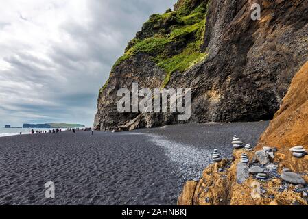 View at Reynisfjara  black sand beach in Southern Iceland. Reynisfjall mountain wall and Gardar basalt columns are at right. Stock Photo