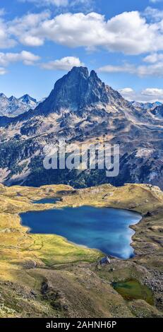 Vertical panoramic view at Midi Ossau mountain peak and Lake Gentau from the mountain pass Ayous in Franch Atlantic Pyrenees, as seen in October. Aqui Stock Photo