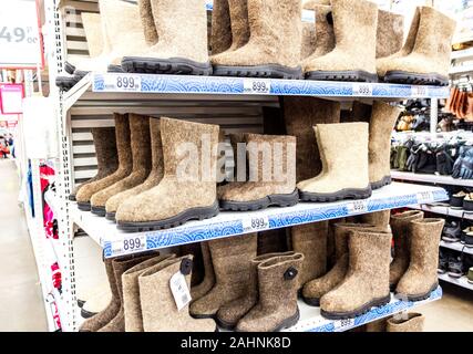 Samara, Russia - December 14, 2019: Felt boots made of sheep wool on the shelves in supermarket. Russian traditional shoes for winter use Stock Photo