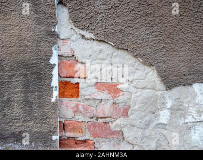 Building damage plaster on a house wall Stock Photo