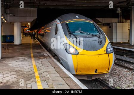 Passengers board an Avanti Class 390 Pendolino train at Birmingham New Street Railway Station, Birmingham, West Midlands, UK. Stock Photo