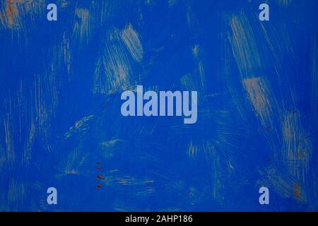 abandoned and decaying strong blue color metal plate in an abandoned industrial complex with visible paintbrush traces siutable as background Stock Photo