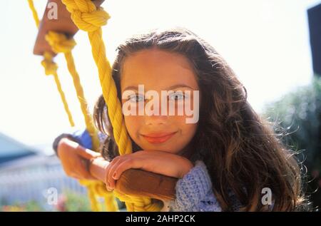 Close up of a cute girl hanging on to a ladder. Stock Photo