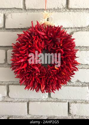 Chilli rista wreath made from Hatch Chillies hanging on the wall inside a house in Arizona Stock Photo