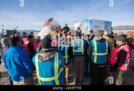 Louis Atchison, chief of launch and recovery operations, Boeing Commercial Crew Program, speaks to the teams from NASA, Boeing, and the White Sands Missile Range, after the Boeing CST-100 Starliner spacecraft landed following an abbreviated Orbital Flight Test at White Sands Missile Range December 22, 2019 in White Sands, New Mexico. The Boeing Starliner spacecraft failed to dock with the International Space Station due to an internal clock failure and returned early to Earth. Stock Photo