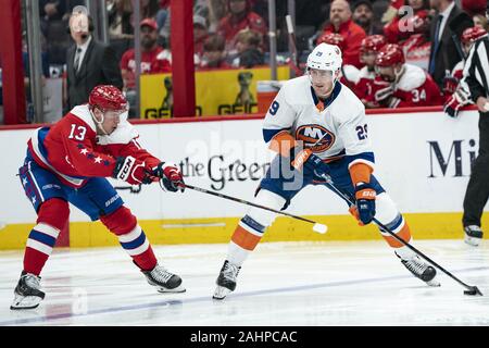 Washington, United States. 31st Dec, 2019. New York Islanders center Brock Nelson (29) skates with the puck while defended by Washington Capitals left wing Jakub Vrana (13) during the first period at Capital One Arena in Washington, DC on Tuesday, December 31, 2019. The Washington Capitals finish the decade as the winningest team in the NHL with 465 wins since 2010. Photo by Alex Edelman/UPI Credit: UPI/Alamy Live News Stock Photo