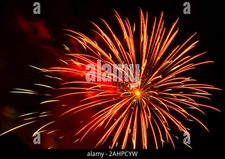 vibrant red fireworks display against black sky Stock Photo