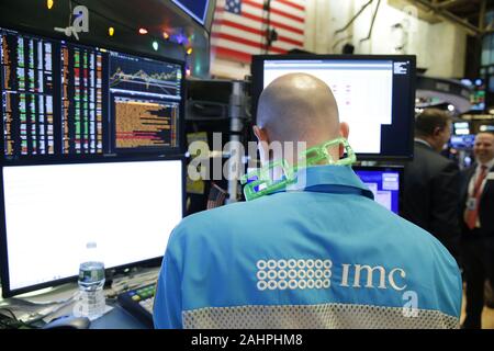 New York, United States. 31st Dec, 2019. Traders wearing 2020 glasses work on the the floor of the New York Stock Exchange on New Year's Eve on the last day of trading for 2019 at the Closing Bell on Wall Street in New York City on Friday, December 31, 2019. Photo by John Angelillo/UPI Credit: UPI/Alamy Live News Stock Photo