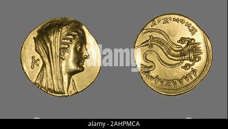 Ancient Egyptian. Octadrachm (Coin) Portraying Arsinoe II. 276 BC–261 BC. Egypt. Gold The purpose of the first portrait coins was to identify the ruler. The front side became a mirror of the sovereign’s self-image. The back was often used to communicate the ruler’s accomplishments or intentions. The profile portrait was used because it suited the very shallow depth and limited surface of the coin. The tiny images were carved by engravers into bronze dies, one for the front and another for the back. The coins were then struck, one by one, in a process similar to how modern coins are created tod Stock Photo