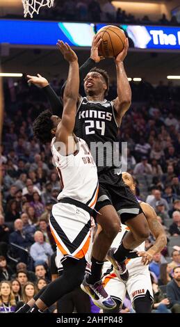 Sacramento, CA, USA. 31st Dec, 2019. Sacramento Kings guard Buddy Hield (24) shoots over LA Clippers guard Derrick Walton Jr. (10) during a game at Golden 1 Center on Tuesday, Dec 31, 2019 in Sacramento. Credit: Paul Kitagaki Jr./ZUMA Wire/Alamy Live News Stock Photo