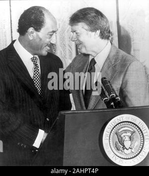 Apr 4, 1977 - Washington, District of Columbia, USA - JIMMY CARTER stands with Egyptian President ANWAR SADAT at a podium with the presidential seal. President Sadat is in town to continue peace terms conversation with President Carter.(Credit Image: © Keystone Press Agency/Keystone USA via ZUMAPRESS.com) Stock Photo