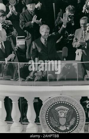 Jan. 20, 1977 - Washington, DC, USA - Newly sworn in President JIMMY CARTER waves from the balcony on the east portico of the Capitol building during his Inauguration ceremony. Carter is the 39th President of the United States. Former President GERALD FORD claps, left. (Credit Image: © Keystone Press Agency/Keystone USA via ZUMAPRESS.com) Stock Photo