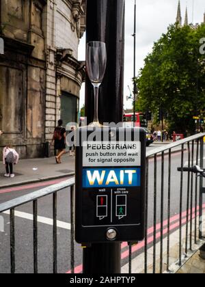 a glass of champagne on top of a London traffic light Stock Photo