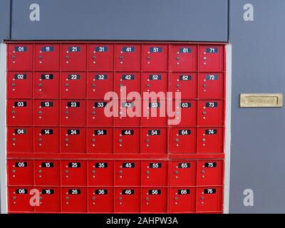 Red numbered 01 to 76 post office boxes at a mail centre in New Zealand. Stock Photo