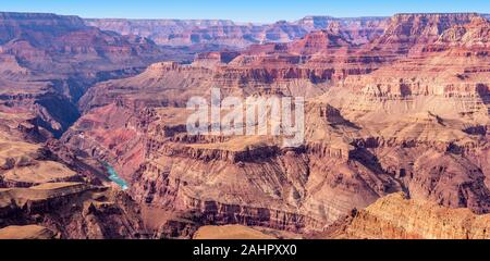 A view of the Colorado River weaving through valleys and rugged Grand Canyon terrain. Stock Photo