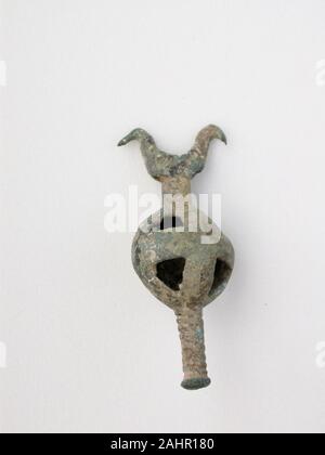 Ancient Greek. Double Birds on Openwork Sphere with Post. 800 BC–600 BC. Thessaly. Bronze This precious bronze object is a votive, or devotional gift, made as an offering to the gods. They come in many forms, such as animals, beads and brooches. Many seem once to have been attached to something else. Votives were hung from sacred trees or placed in sanctuaries around Greece. Once a shrine was full, the votives were ceremonially buried to make room for more offerings. Stock Photo