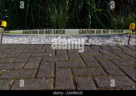 Signage tape restricts access on a path Stock Photo