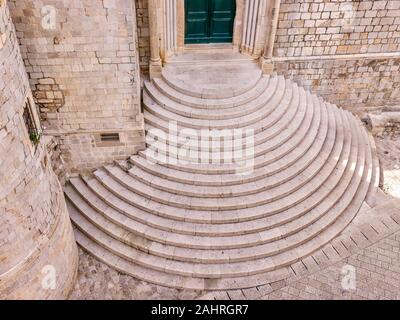 High angle view of the medieval semi circular stone staircase outside the entrance to the Dominican Monastery in the Old Town of Dubrovnik, Croatia. Stock Photo