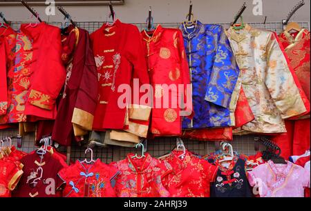Chinese male traditional dresses called changshan, lower row are female dresses called cheongsam or qipao, usually worn during chinese celebration Stock Photo