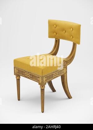 John Philip Fondé. Side Chair. 1816. Philadelphia. Ash, white pine, white oak, and painted decoration This side chair is one of a set of 10 made for Major David Lenox’s summer home in Bristol, Pennsylvania. The painted decoration, by Philadelphia sign painter John Philip Fondé, is meant to resemble maple, reflecting the popularity of maple and satinwood Neoclassical furniture. In addition, ornamentation imitating ormolu mounts and metal inlay enhances visual interest, providing a contrast between matte and polished surfaces. The dramatic curves of the tablet back, rear saber legs, and stiles r Stock Photo