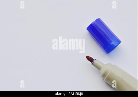 blue permanent marker pen and cover on white paper Stock Photo