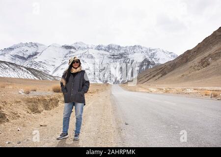 Travelers thai woman travel visit and posing for take photo with landscape high range mountain on Srinagar Leh Ladakh highway at Leh Ladakh village in Stock Photo