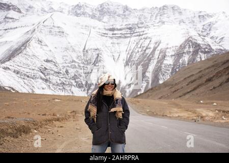 Travelers thai woman travel visit and posing for take photo with landscape high range mountain on Srinagar Leh Ladakh highway at Leh Ladakh village in Stock Photo