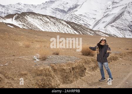 Travelers thai woman travel visit and posing for take photo with landscape high range mountain on Srinagar Leh Ladakh highway at Leh Ladakh village in Stock Photo