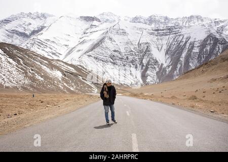 Travelers thai woman travel visit and posing for take photo with landscape high range mountain on Srinagar Leh Ladakh highway at Leh Ladakh village in Stock Photo